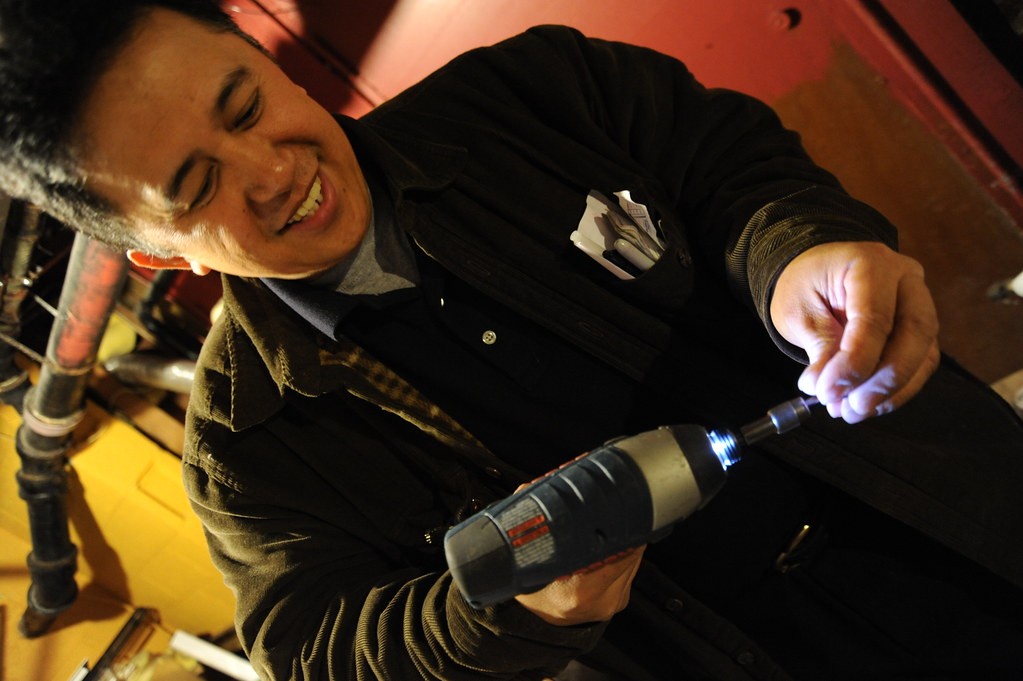Appliance repair technician performing a service repair