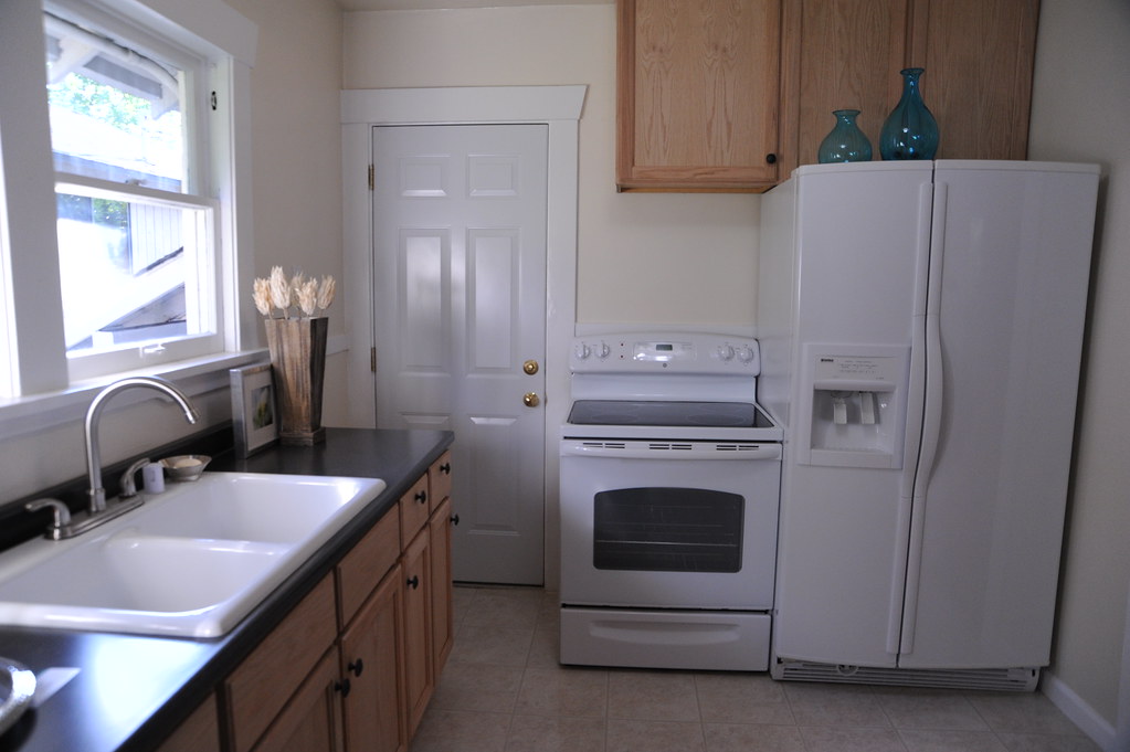 Kitchen with refrigerator and range